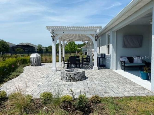 view of patio featuring a pergola and an outdoor fire pit