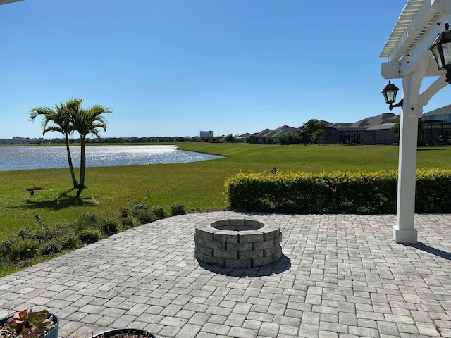 view of patio / terrace featuring a water view and a fire pit