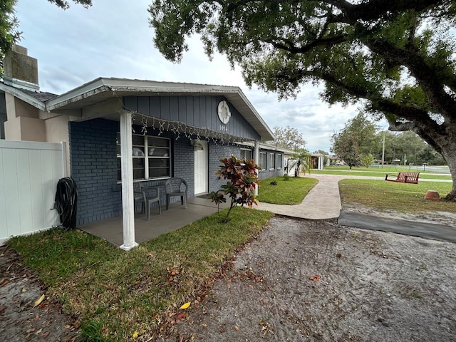 view of side of property with a yard