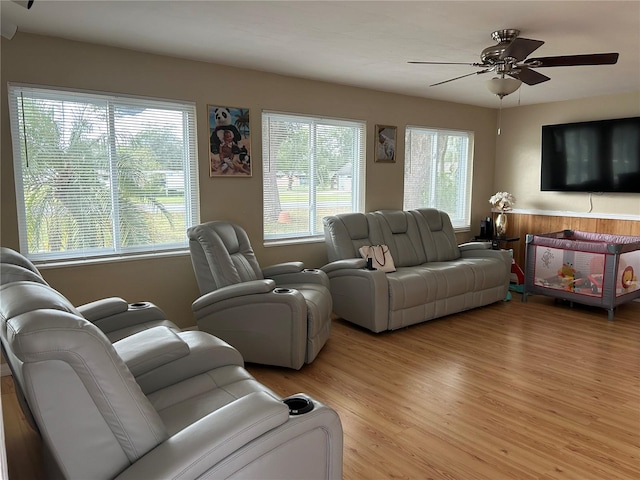 living room with ceiling fan and light hardwood / wood-style flooring