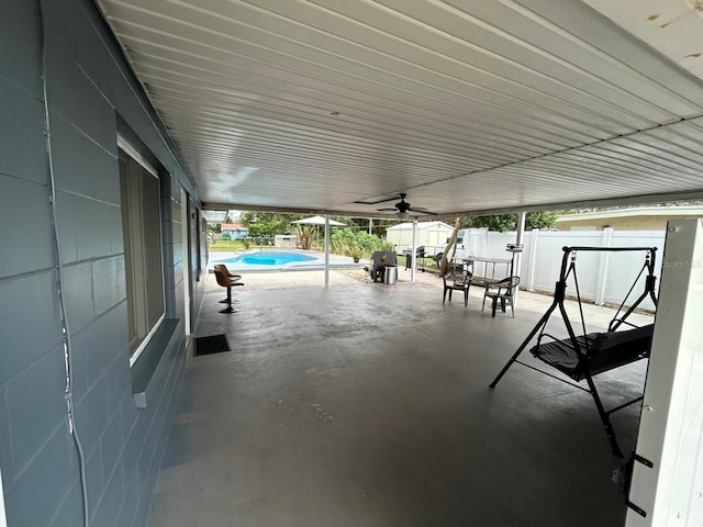 view of patio with ceiling fan and a fenced in pool