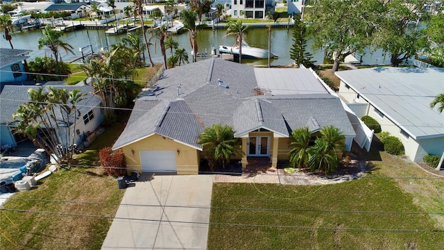 birds eye view of property with a residential view and a water view