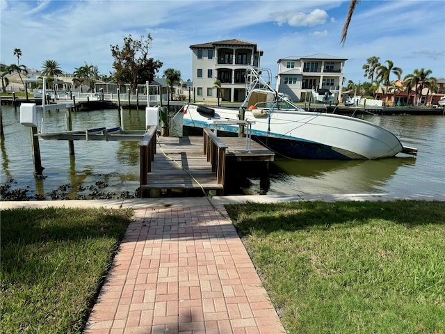 dock area featuring a yard and a water view