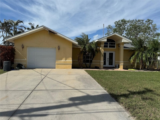 view of front of property featuring a garage, a front lawn, and french doors