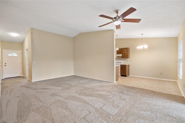 unfurnished living room featuring ceiling fan with notable chandelier, light colored carpet, a textured ceiling, and vaulted ceiling