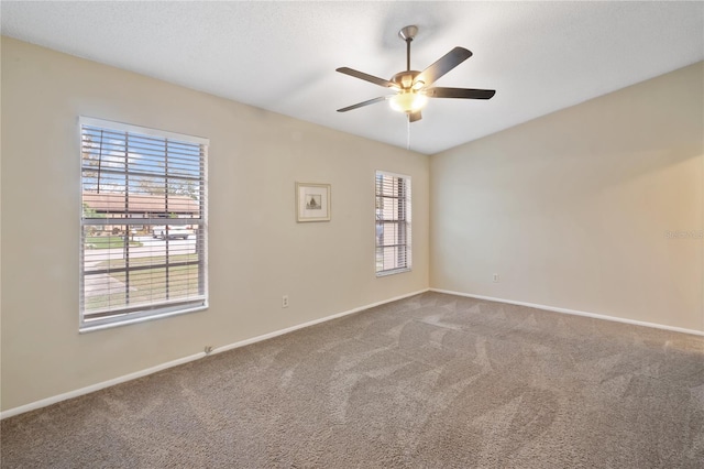 carpeted spare room with ceiling fan