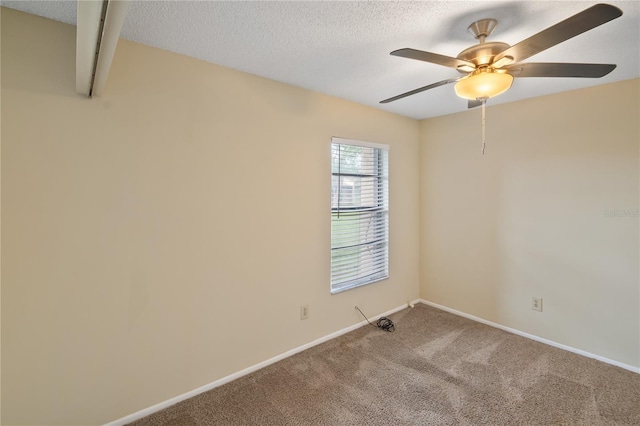 empty room with a textured ceiling, ceiling fan, and carpet floors