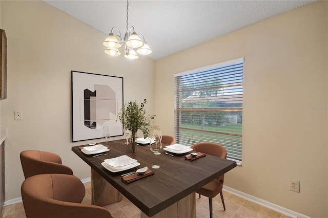 dining space featuring baseboards and an inviting chandelier