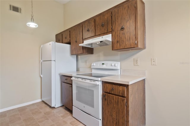 kitchen with white appliances, visible vents, light countertops, under cabinet range hood, and pendant lighting