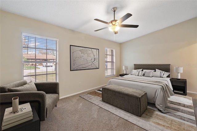 bedroom featuring carpet, a ceiling fan, and baseboards