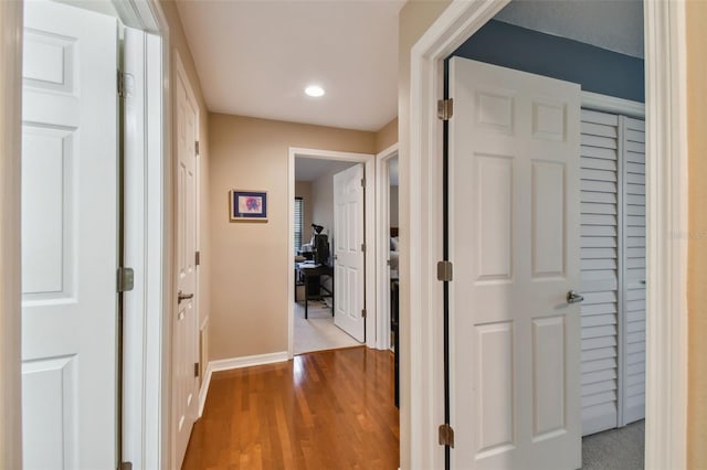 hallway with light hardwood / wood-style floors