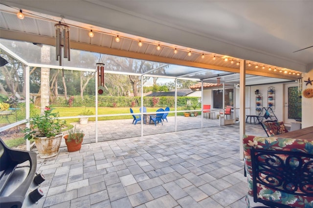 view of patio / terrace featuring glass enclosure