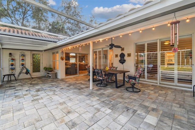 sunroom featuring ceiling fan