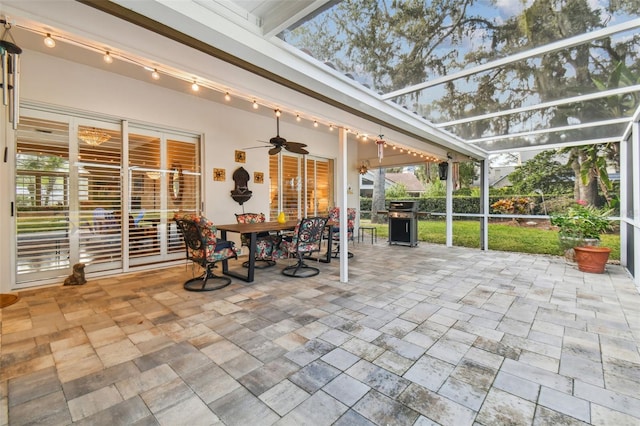 sunroom with track lighting and ceiling fan