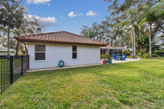 view of property exterior featuring a patio area and a yard