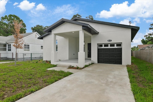 view of front facade with a garage, a front yard, and a porch