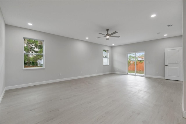 spare room featuring light wood-type flooring and ceiling fan