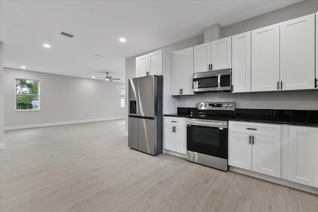 kitchen with white cabinetry, appliances with stainless steel finishes, light hardwood / wood-style floors, and ceiling fan