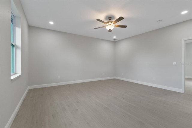 spare room featuring ceiling fan and light hardwood / wood-style floors