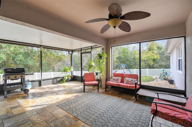 sunroom / solarium with plenty of natural light and ceiling fan