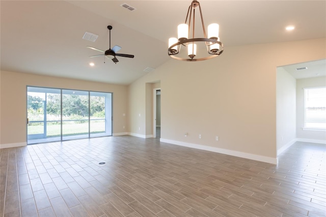 empty room with a wealth of natural light, light hardwood / wood-style floors, and vaulted ceiling