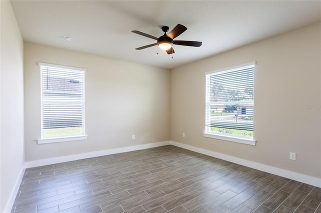 spare room with hardwood / wood-style floors and ceiling fan