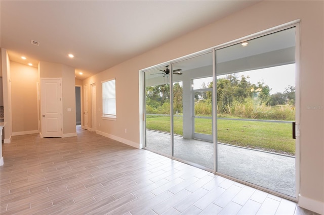 doorway featuring ceiling fan and light wood-type flooring