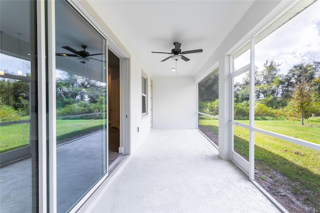 unfurnished sunroom featuring ceiling fan