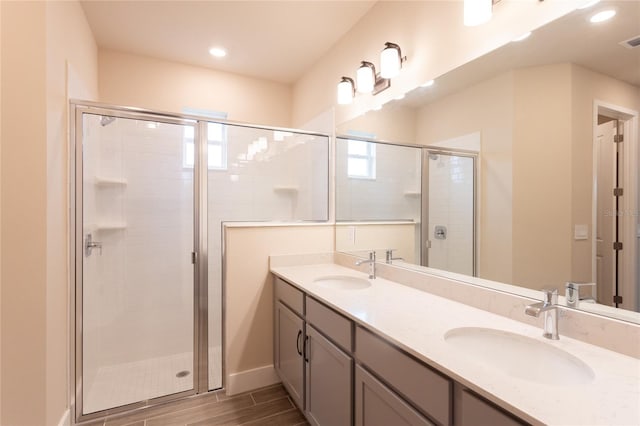 bathroom with vanity and a shower with door