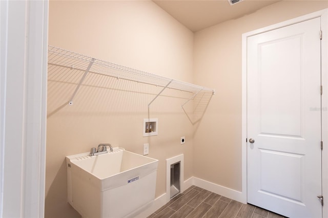 laundry room with washer hookup, wood-type flooring, hookup for an electric dryer, and sink