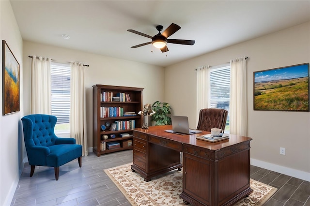 office space featuring a wealth of natural light, wood-type flooring, and ceiling fan