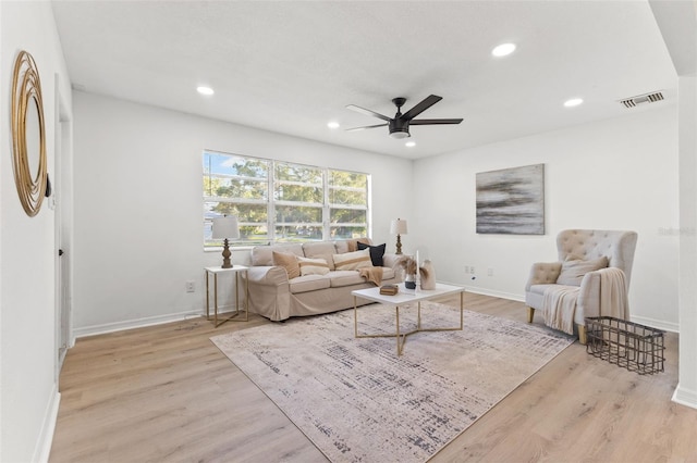 living room featuring ceiling fan and light hardwood / wood-style flooring