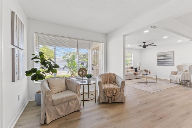 sitting room with ceiling fan, a healthy amount of sunlight, and light hardwood / wood-style flooring