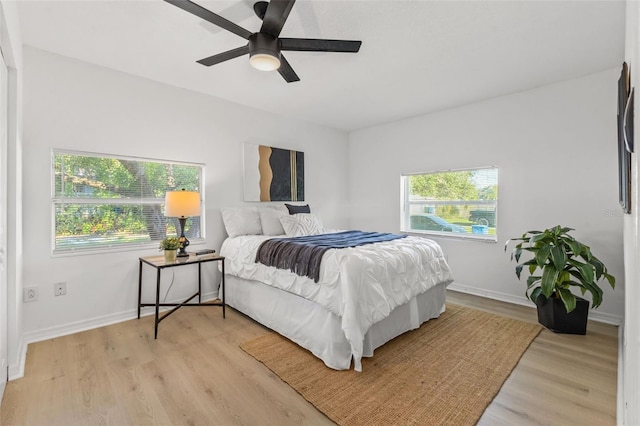 bedroom with light hardwood / wood-style floors and ceiling fan