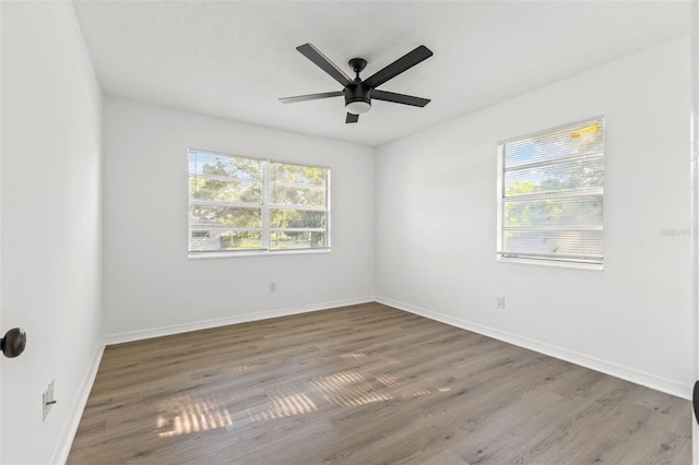 spare room featuring dark wood-type flooring and ceiling fan