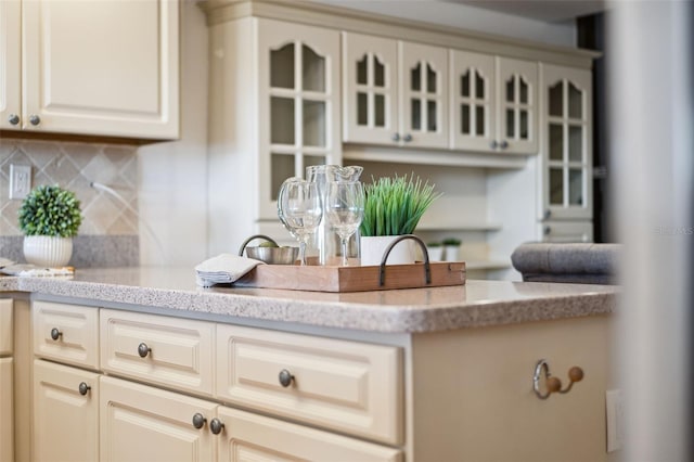 kitchen featuring decorative backsplash and cream cabinetry