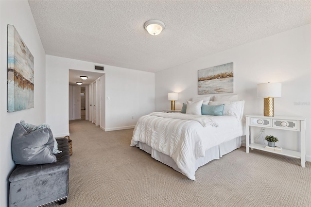 carpeted bedroom featuring a textured ceiling