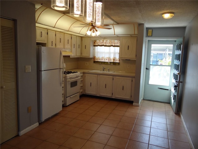 kitchen featuring white appliances, sink, ceiling fan, a textured ceiling, and light tile patterned flooring