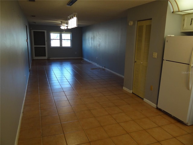 spare room featuring light tile patterned floors and ceiling fan