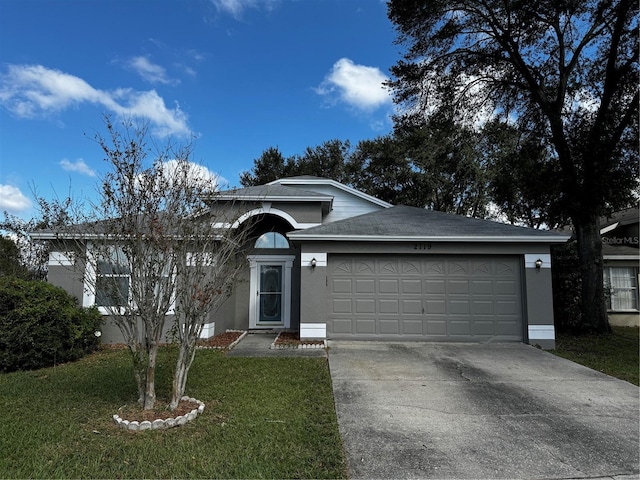 view of front of home featuring a garage and a front lawn