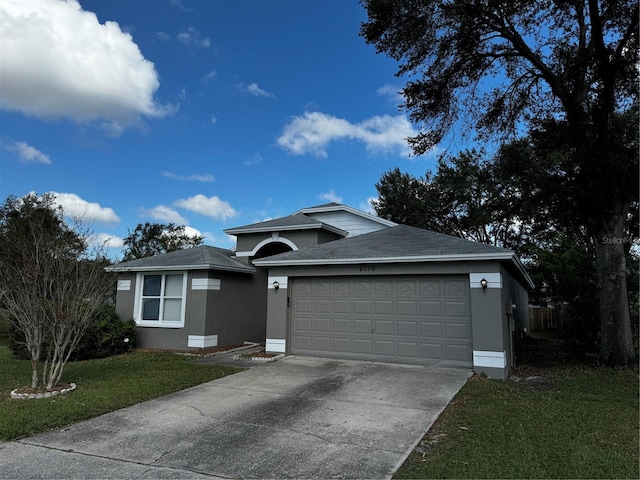 view of front facade featuring a front lawn and a garage