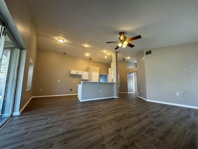 unfurnished living room featuring dark wood-type flooring and ceiling fan