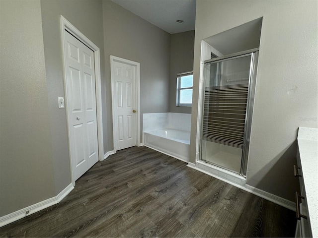 bathroom featuring hardwood / wood-style floors and plus walk in shower