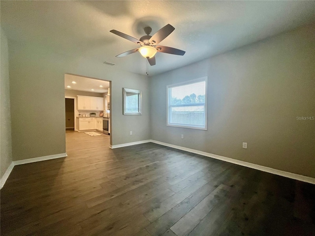 empty room featuring hardwood / wood-style flooring and ceiling fan