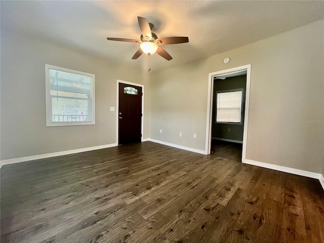 interior space featuring ceiling fan, a healthy amount of sunlight, and dark hardwood / wood-style floors