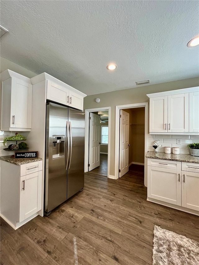 kitchen with white cabinetry, stainless steel refrigerator with ice dispenser, and dark hardwood / wood-style floors