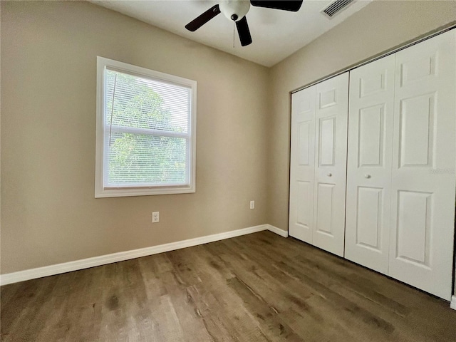 unfurnished bedroom featuring a closet, ceiling fan, and dark hardwood / wood-style floors