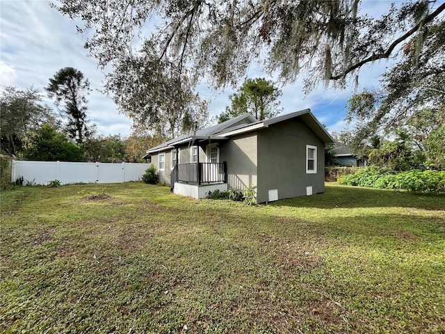 back of house featuring a yard