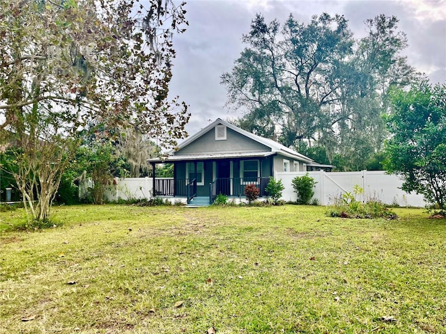 view of front of property with a porch and a front lawn