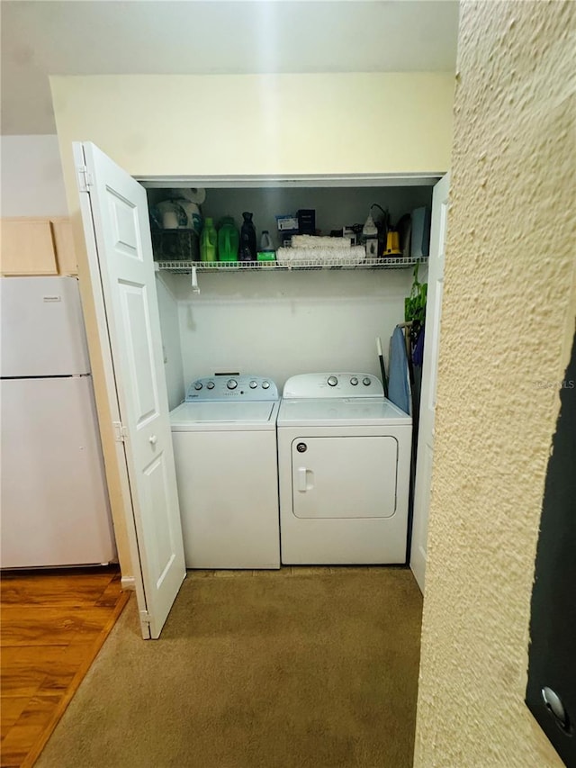 clothes washing area with carpet flooring and washing machine and dryer